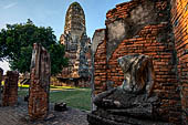 Ayutthaya, Thailand. Wat Chaiwatthanaram, ruins and one headless Buddha statue of the gallery. 